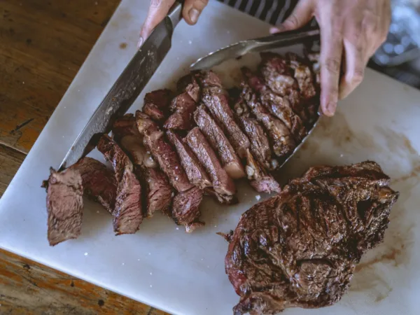 Is The Carnivore Only Diet Actually Successful Or Healthy? 3 Close-Up Shot of a Person Slicing Cooked Meat