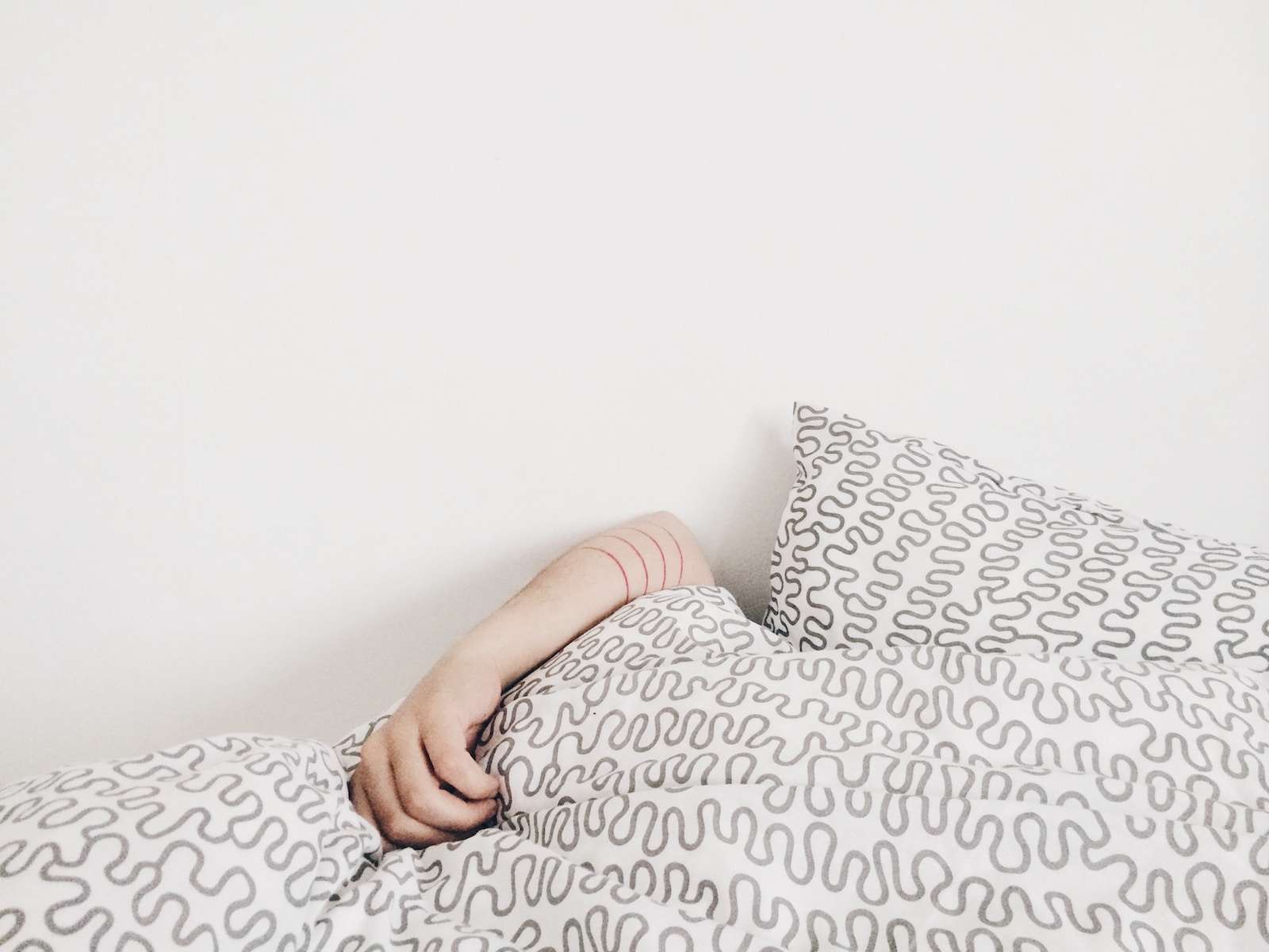 Photo by elizabeth lies person lying on bed