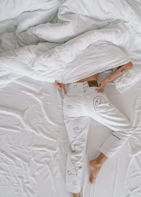 Photo by Toa Heftiba 1 woman in white dress lying on bed