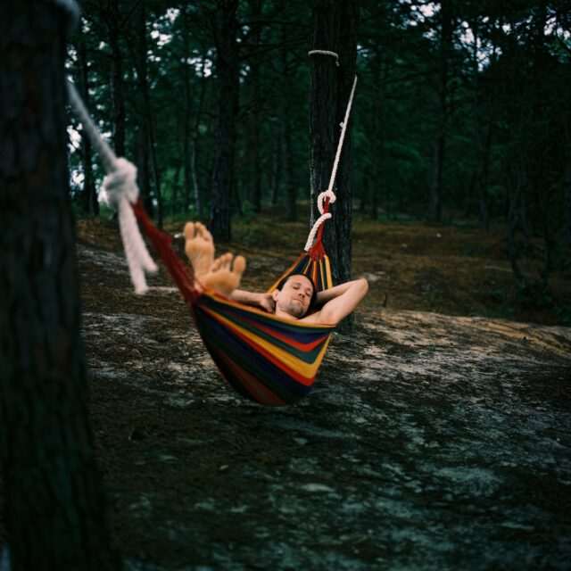 Photo by Keren Fedida 1 woman in white and blue striped hammock