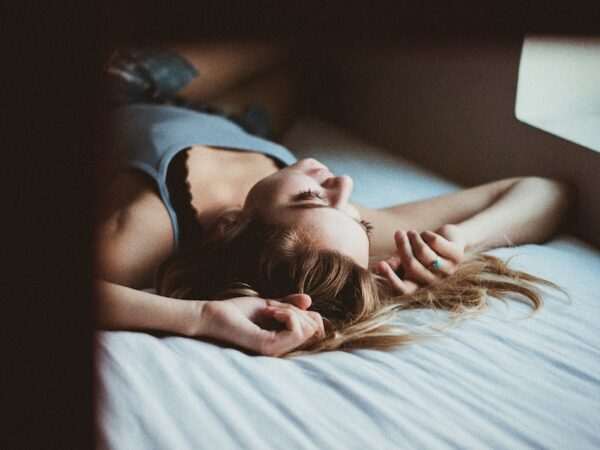 How To Develop The Habit Of Sleeping Early? 5 woman lying on bed inside room screengrab