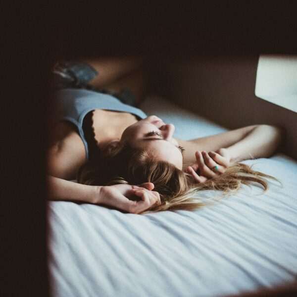 woman lying on bed inside room screengrab