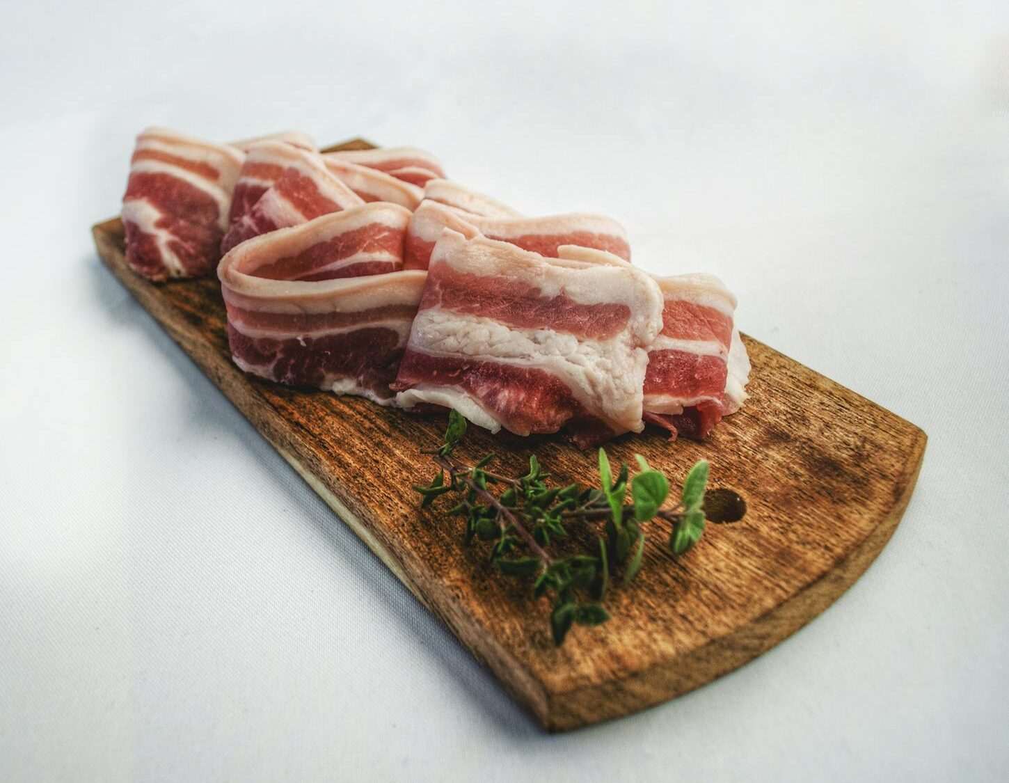 What Should I Expect On A Carnivore Diet? 13 Food Photography of Sliced Bacon on Top of Brown Chopping Board