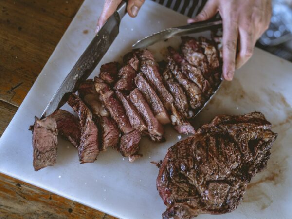 Close-Up Shot of a Person Slicing Cooked Meat